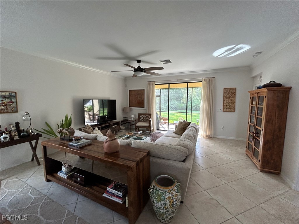 8963 Water Tupelo Road Fort Myers, FL 33912 - Photo 18 of 37 a living room with furniture a flat screen tv and a large window