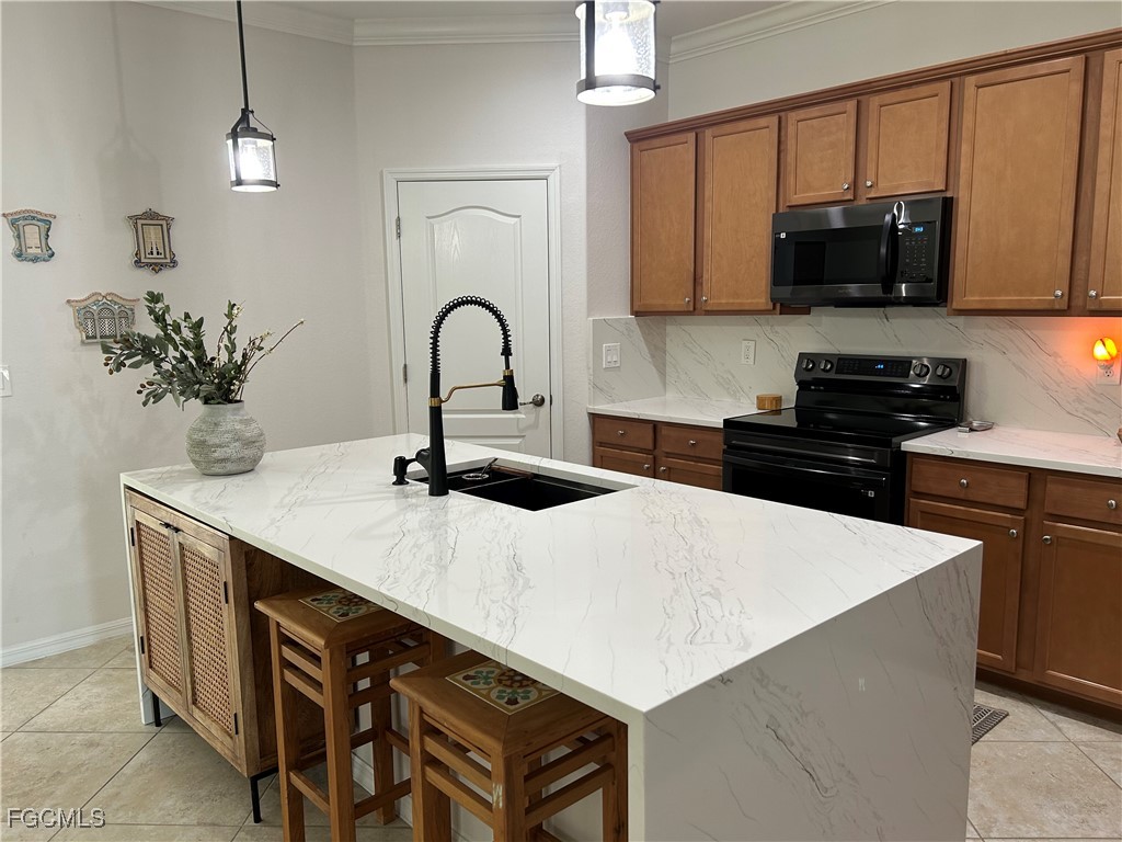 8963 Water Tupelo Road Fort Myers, FL 33912 - Photo 21 of 37 a kitchen with stainless steel appliances a sink a stove a microwave a sink a refrigerator and cabinets