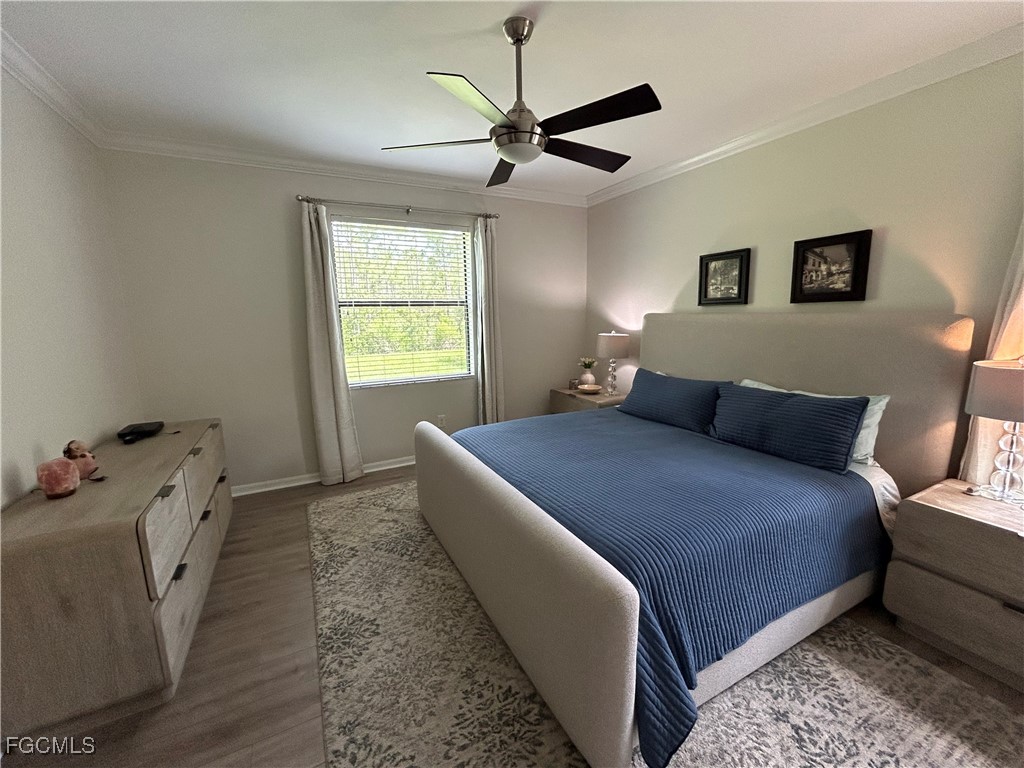 8963 Water Tupelo Road Fort Myers, FL 33912 - Photo 27 of 37 a bedroom with a bed and a window