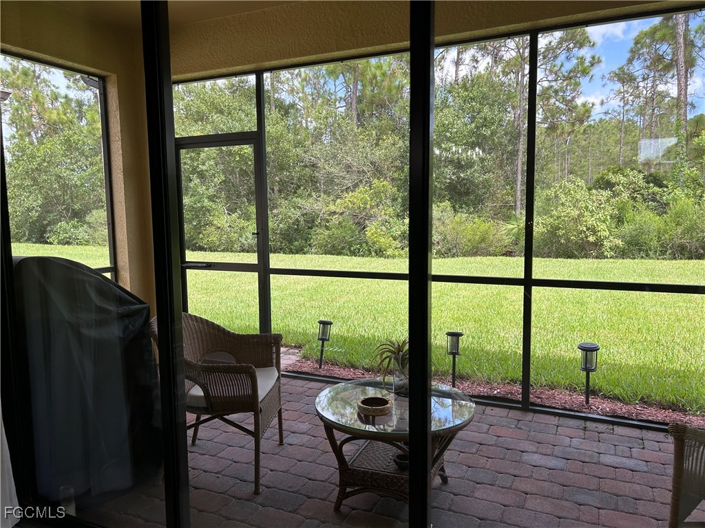 8963 Water Tupelo Road Fort Myers, FL 33912 - Photo 8 of 37 a view of a room with a large window and chairs