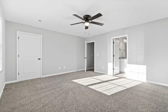 a view of a livingroom with a ceiling fan and window