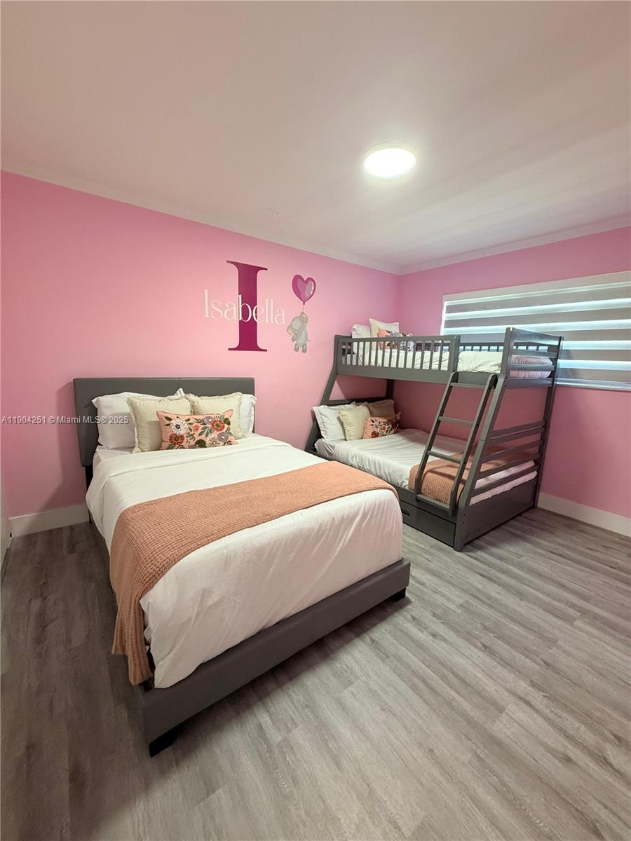 8721 Southwest 191st Street Cutler Bay, FL 33157 - Photo 11 of 15 a bedroom with a bed and wooden floor