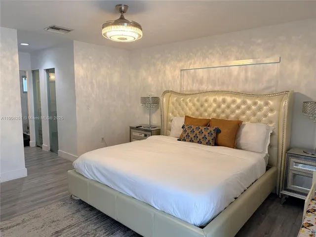 a bedroom with a bed and a lamp