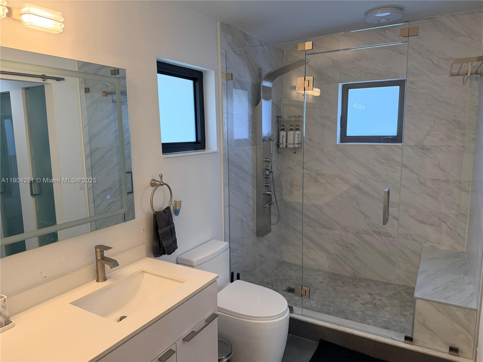 8721 Southwest 191st Street Cutler Bay, FL 33157 - Photo 15 of 15 a bathroom with a sink toilet and shower