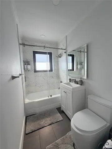 a bathroom with a toilet a sink and bathtub