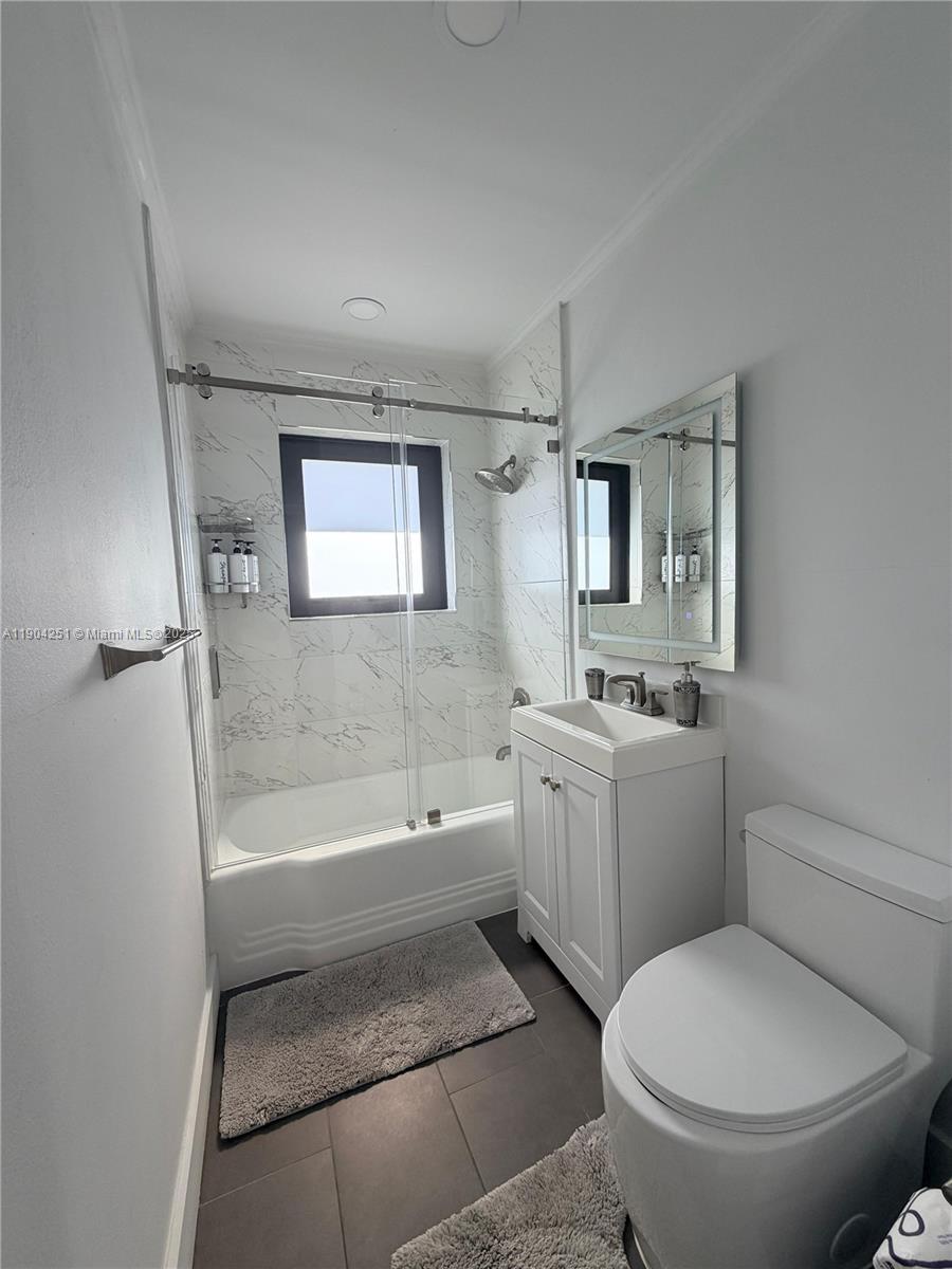 8721 Southwest 191st Street Cutler Bay, FL 33157 - Photo 8 of 15 a bathroom with a toilet a sink and bathtub