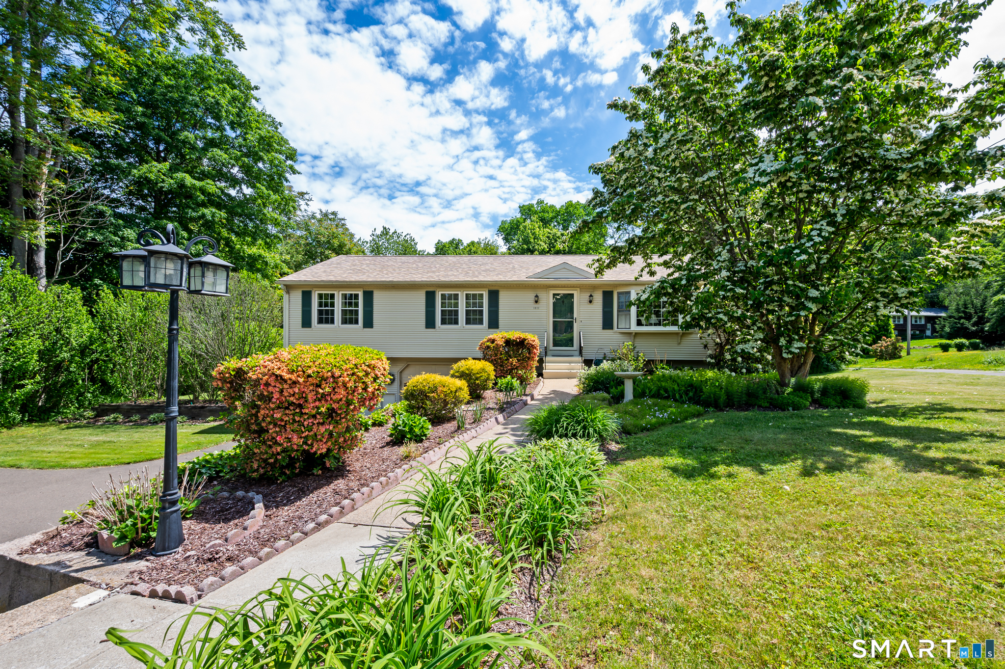 1611 Shepard Avenue Hamden, CT 06518 - Photo 3 of 31 a front view of a house with a yard table and chairs
