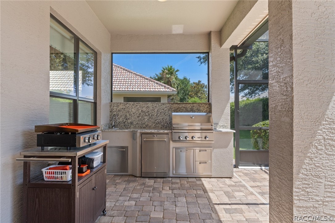 2015 North Rhodes Point Hernando, FL 34442 - Photo 32 of 82 You'll love this Summer Kitchen, complete with Natural Gas Grill, Counter Fridge, and sink.