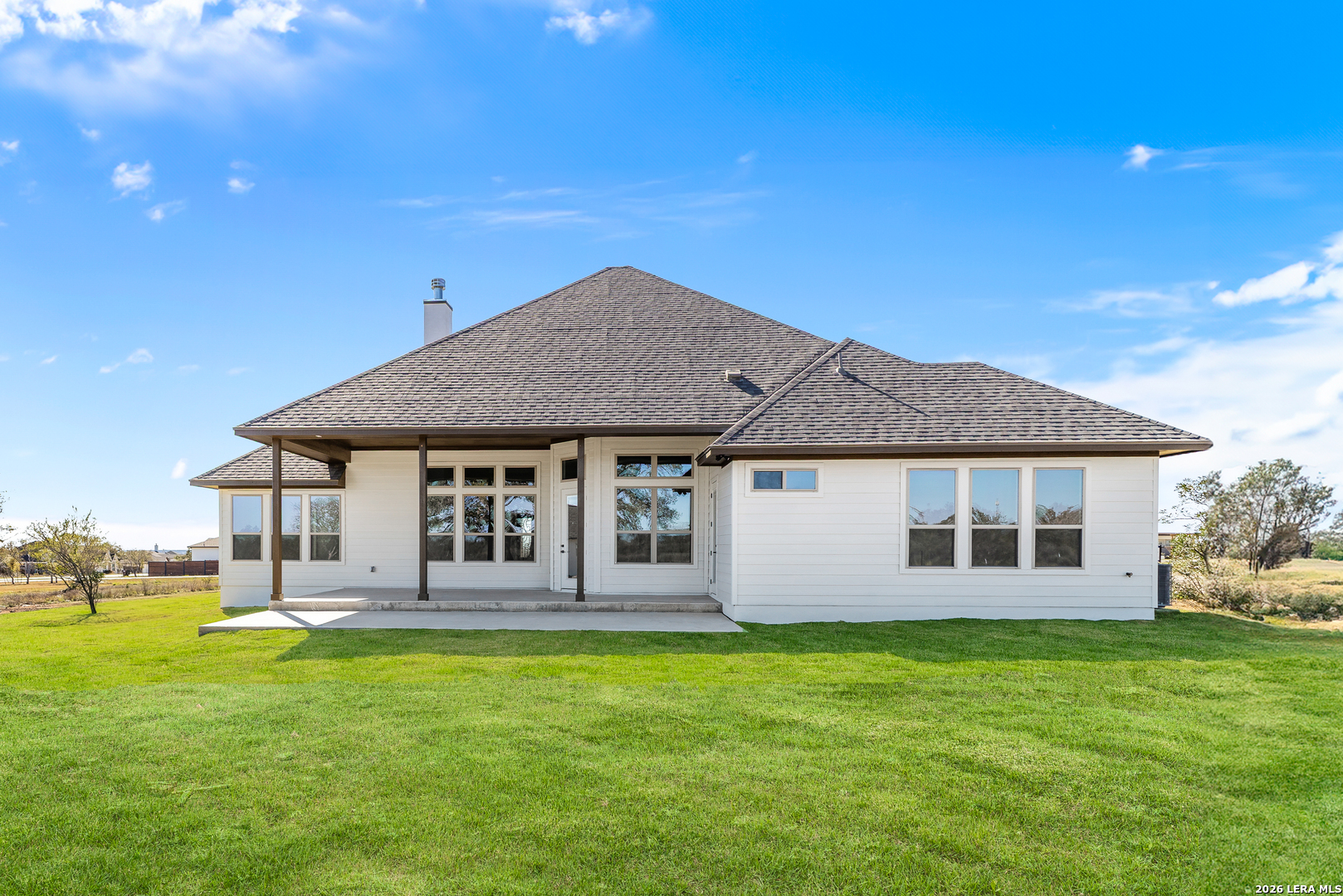 241 Stone Loop Castroville, TX 78009 - Photo 10 of 10 a front view of a house with a garden