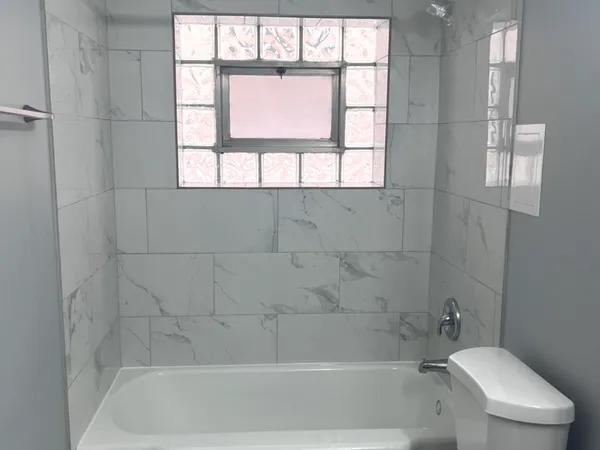 a bath tub sitting next to a window