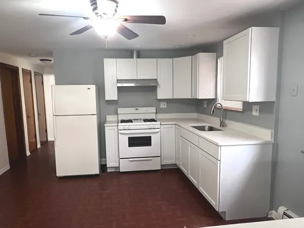 a kitchen with a white cabinets and white appliances