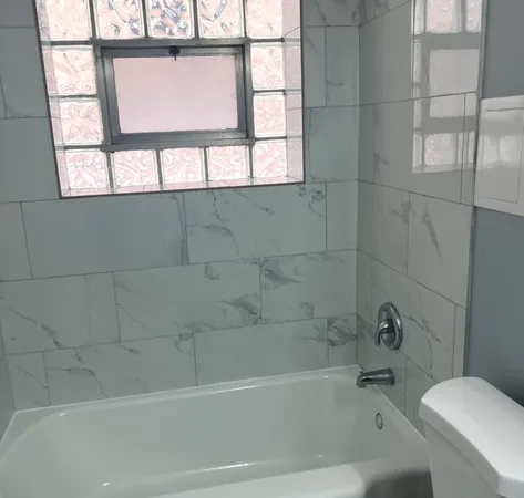 a bath tub sitting next to a window