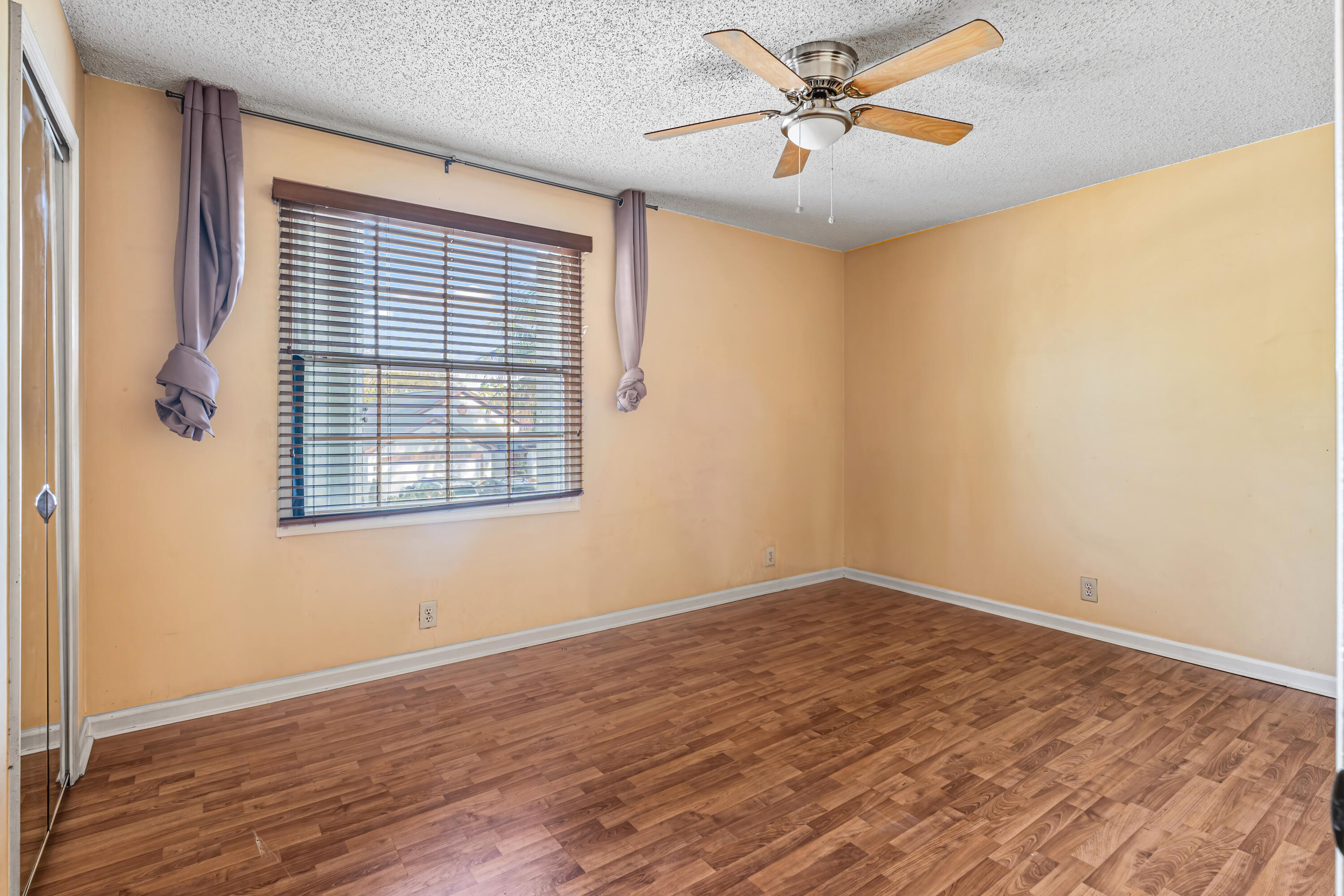 2224 Soundings Court Greenacres, FL 33413 - Photo 13 of 46 an empty room with wooden floor and windows