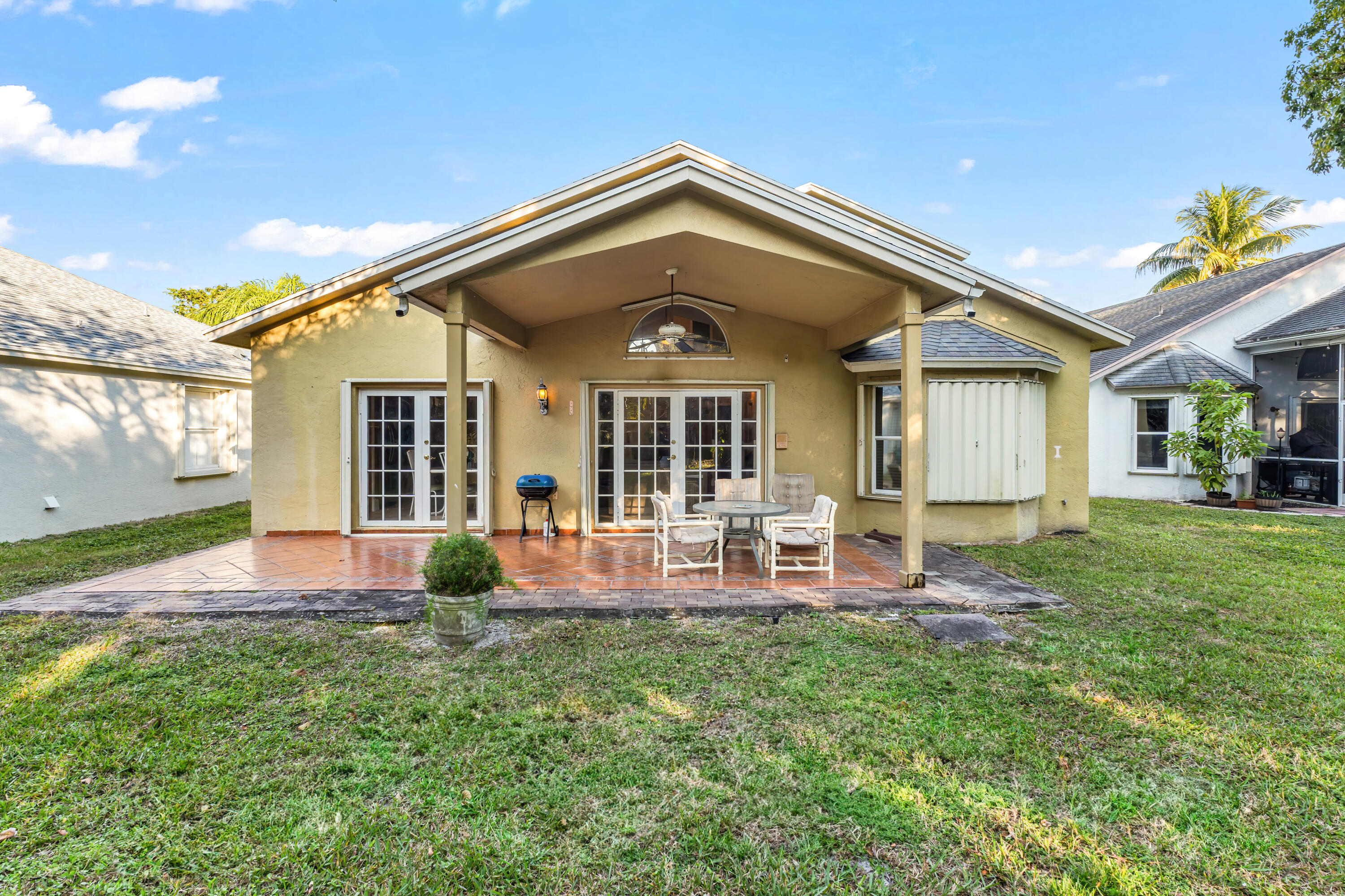 2224 Soundings Court Greenacres, FL 33413 - Photo 23 of 46 a front view of house with yard and outdoor seating