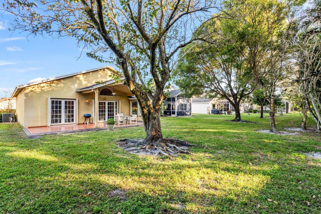 2224 Soundings Court Greenacres, FL 33413 - Photo 25 of 46 a view of a house with a backyard