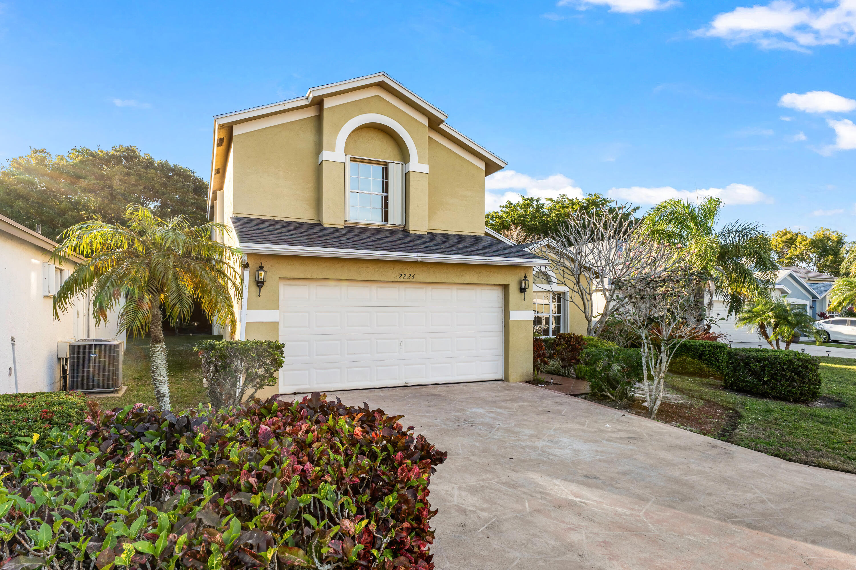 2224 Soundings Court Greenacres, FL 33413 - Photo 27 of 46 a front view of a house with a garden