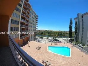 a view of roof deck with patio and lake view