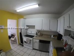 a kitchen with a sink appliances and cabinets