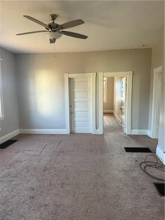 a view of a livingroom with a ceiling fan and window