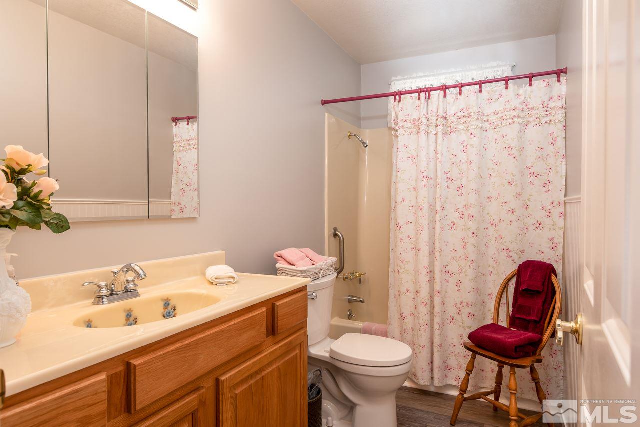 793 Foothill Road Gardnerville, NV 89460 - Photo 13 of 25 a bathroom with a sink toilet and a mirror