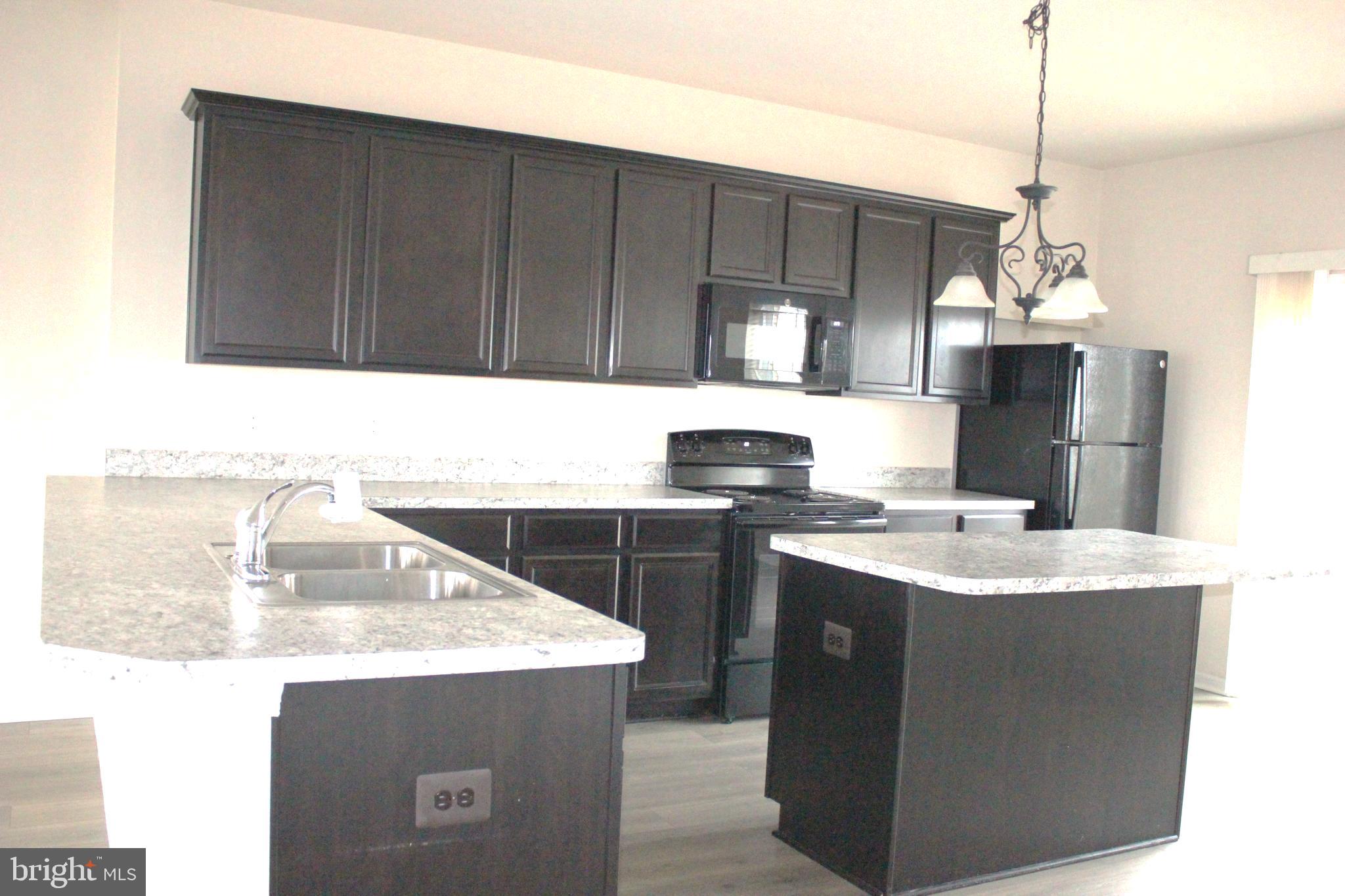 232 Parkland Drive Stephenson, VA 22656 - Photo 4 of 18 a kitchen with a sink cabinets and window