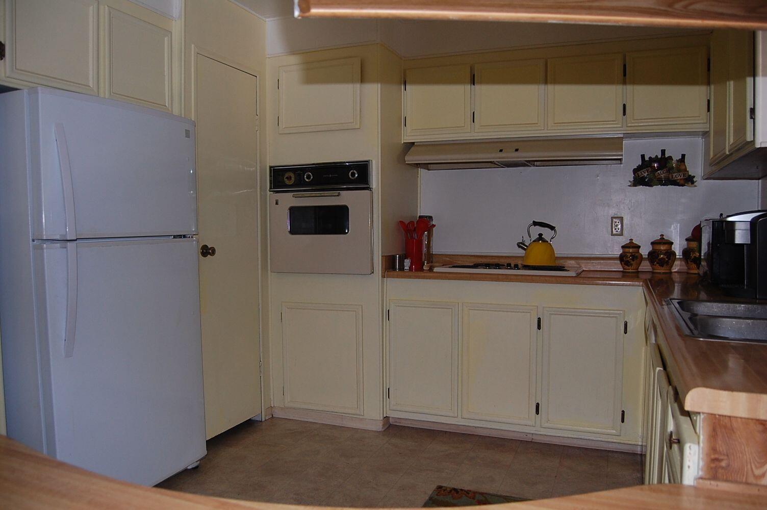 350 Hamilton Avenue Cave Junction, OR 97523 - Photo 7 of 23 a kitchen with a refrigerator and cabinets