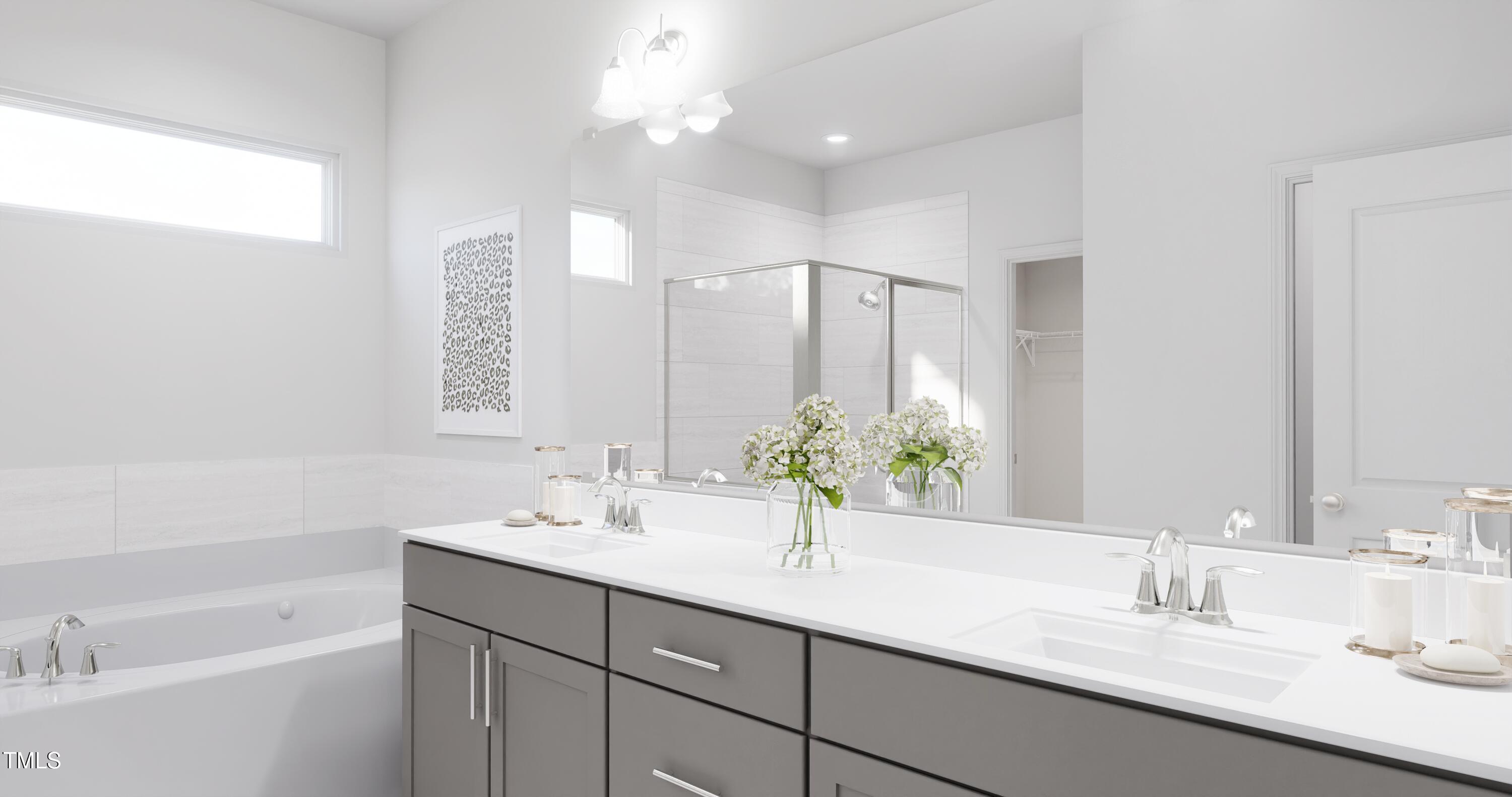 353 Calvander Lane Apex, NC 27539 - Photo 13 of 33 a bathroom with a double vanity sink a mirror and a bathtub