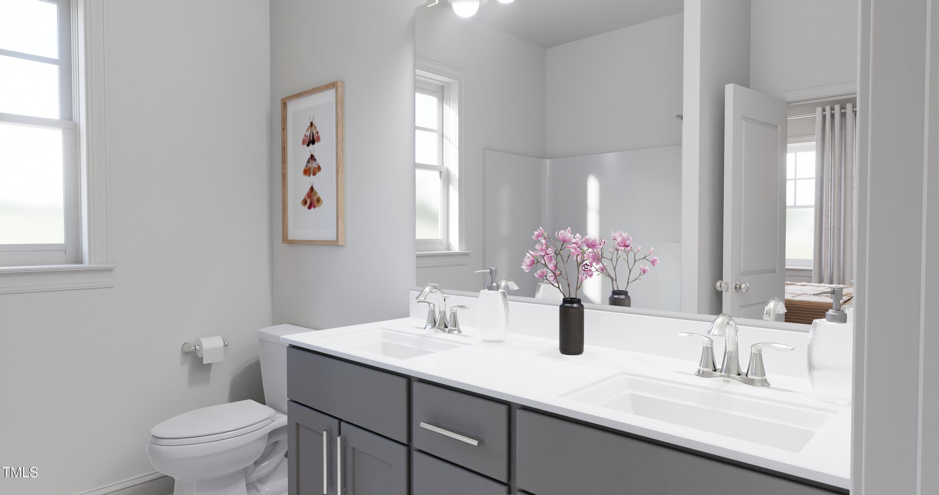 353 Calvander Lane Apex, NC 27539 - Photo 15 of 33 a bathroom with a sink a toilet and a large mirror