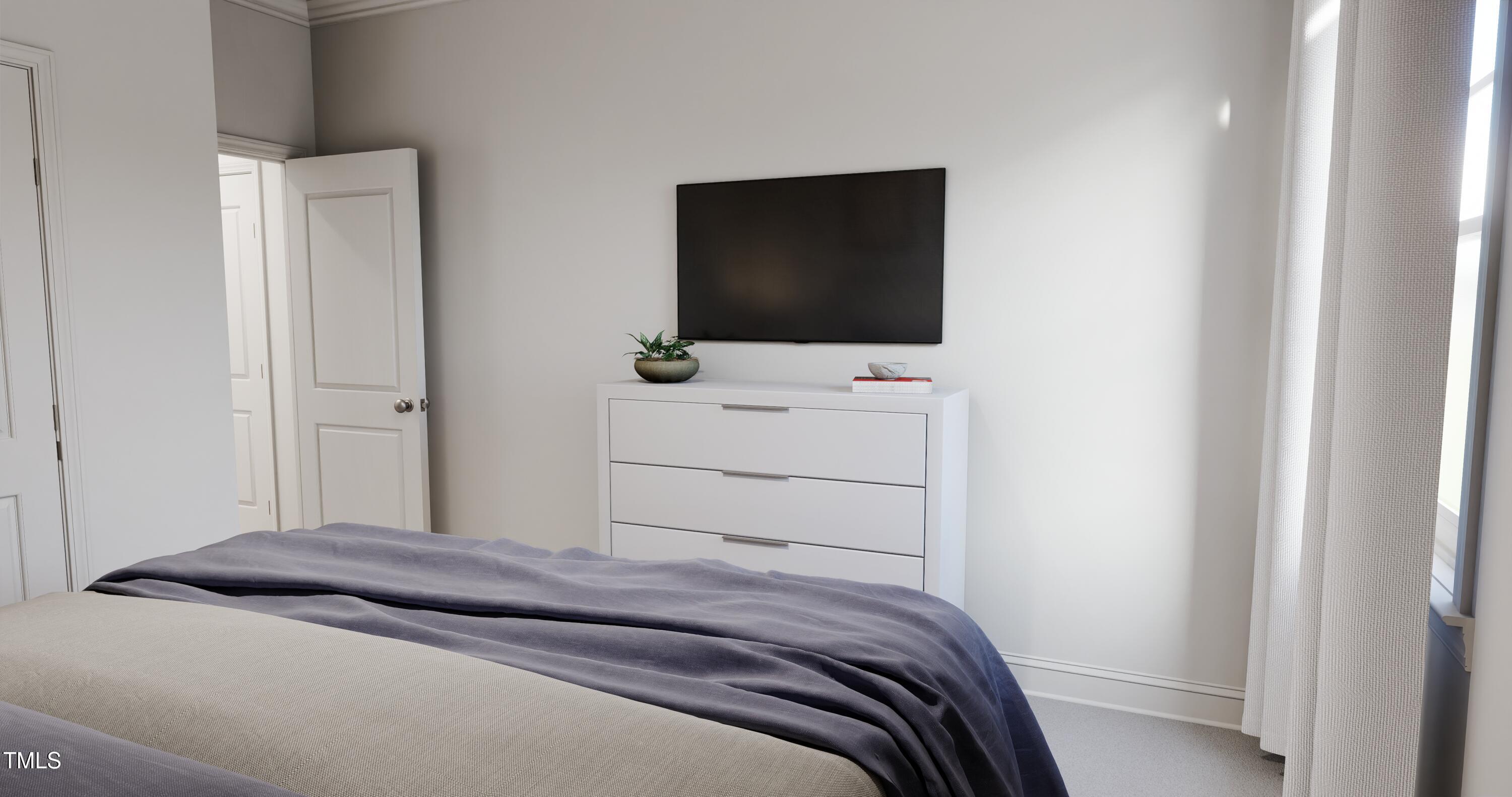 353 Calvander Lane Apex, NC 27539 - Photo 21 of 33 a bedroom with a bed and a flat screen tv
