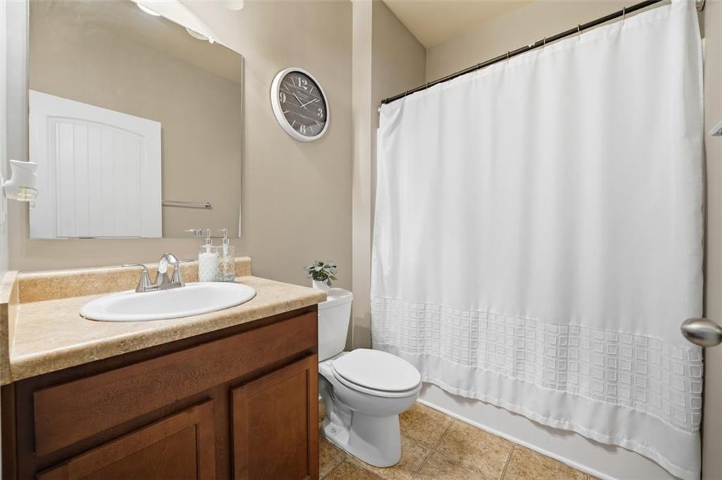 2234 Sawgrass Drive Hampton, GA 30228 - Photo 11 of 28 a bathroom with a sink a toilet and shower