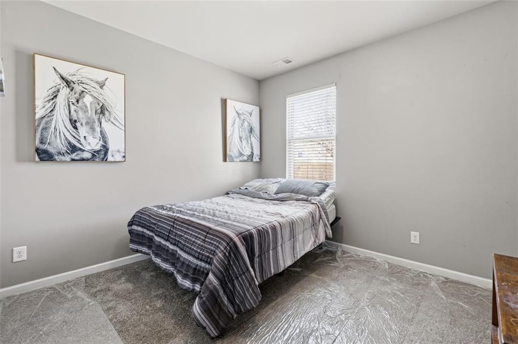 2234 Sawgrass Drive Hampton, GA 30228 - Photo 12 of 28 a bed sitting in a bedroom next to a window