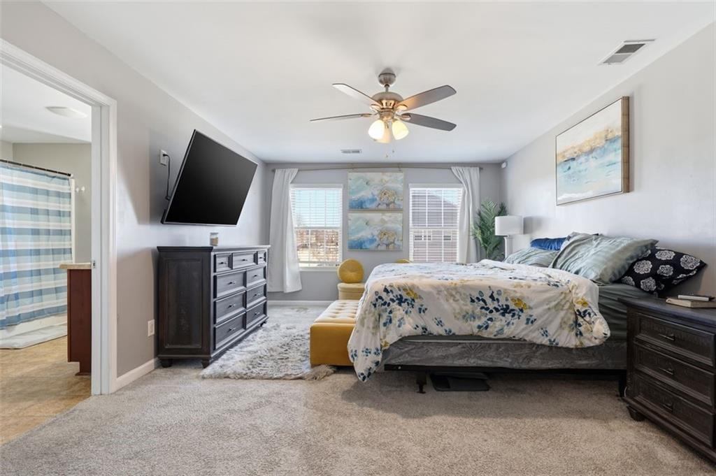 2234 Sawgrass Drive Hampton, GA 30228 - Photo 14 of 28 a bedroom with a bed and a flat screen tv