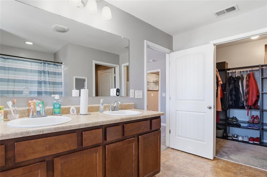 2234 Sawgrass Drive Hampton, GA 30228 - Photo 17 of 28 a bathroom with a sink double vanity and a mirror