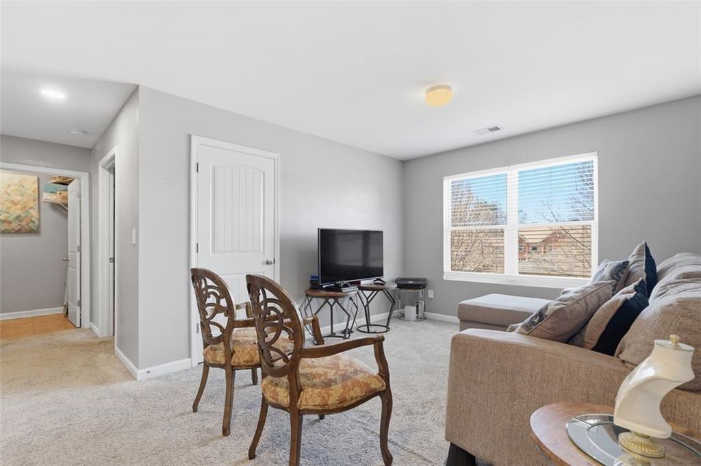 2234 Sawgrass Drive Hampton, GA 30228 - Photo 19 of 28 a living room with furniture and a flat screen tv