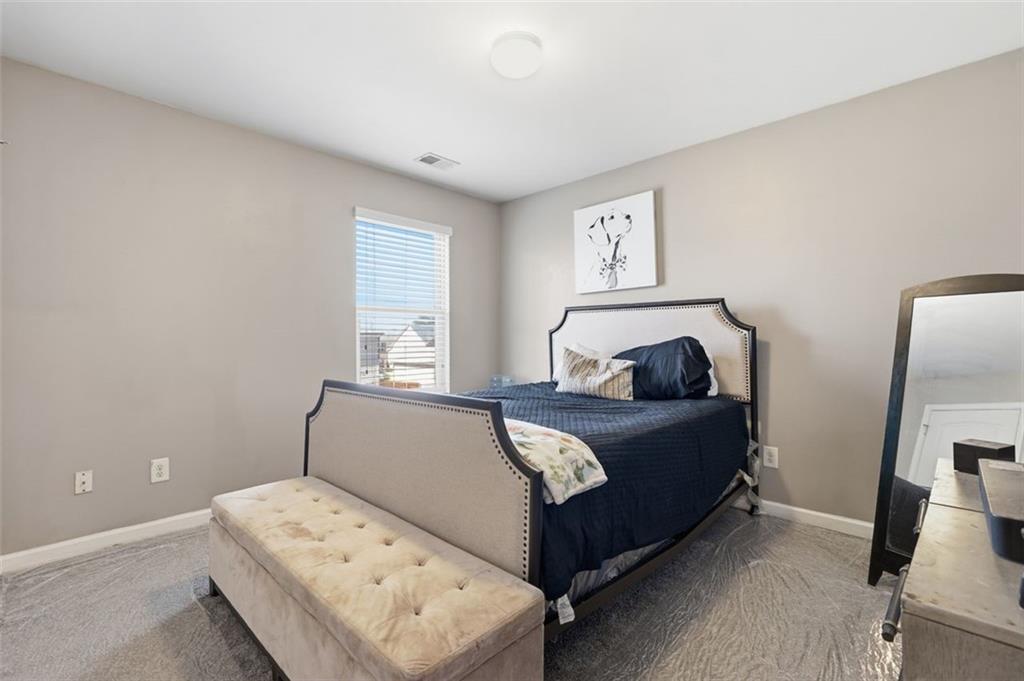 2234 Sawgrass Drive Hampton, GA 30228 - Photo 20 of 28 a bedroom with a bed and a tv on the dresser