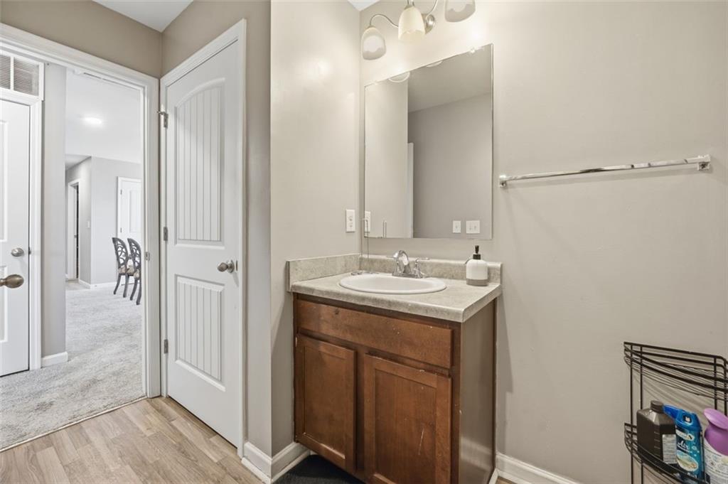 2234 Sawgrass Drive Hampton, GA 30228 - Photo 21 of 28 a bathroom with a sink and mirror