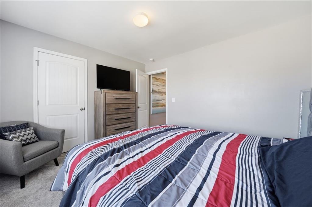 2234 Sawgrass Drive Hampton, GA 30228 - Photo 23 of 28 a bedroom with a bed and a television