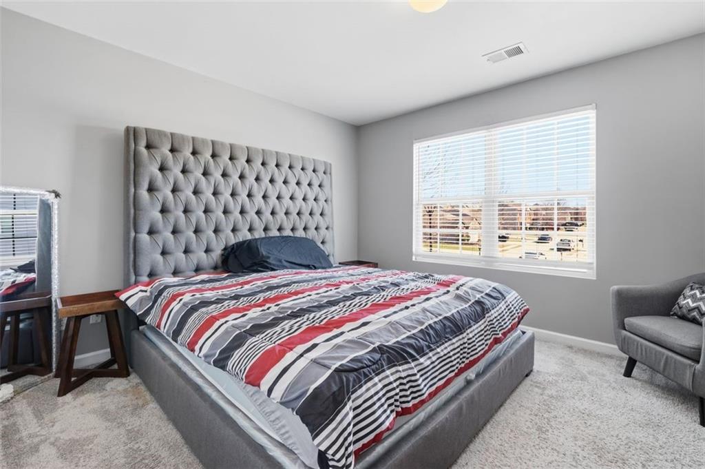 2234 Sawgrass Drive Hampton, GA 30228 - Photo 24 of 28 a bedroom with a bed and a window