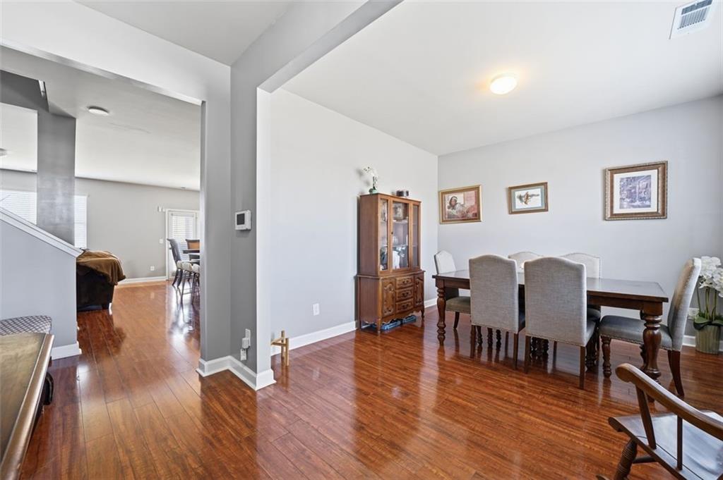 2234 Sawgrass Drive Hampton, GA 30228 - Photo 4 of 28 a view of a dining room with furniture and wooden floor