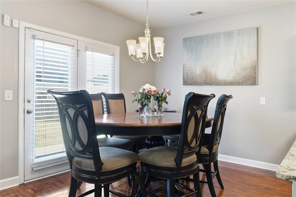 2234 Sawgrass Drive Hampton, GA 30228 - Photo 8 of 28 a view of a dining room with furniture window and wooden floor
