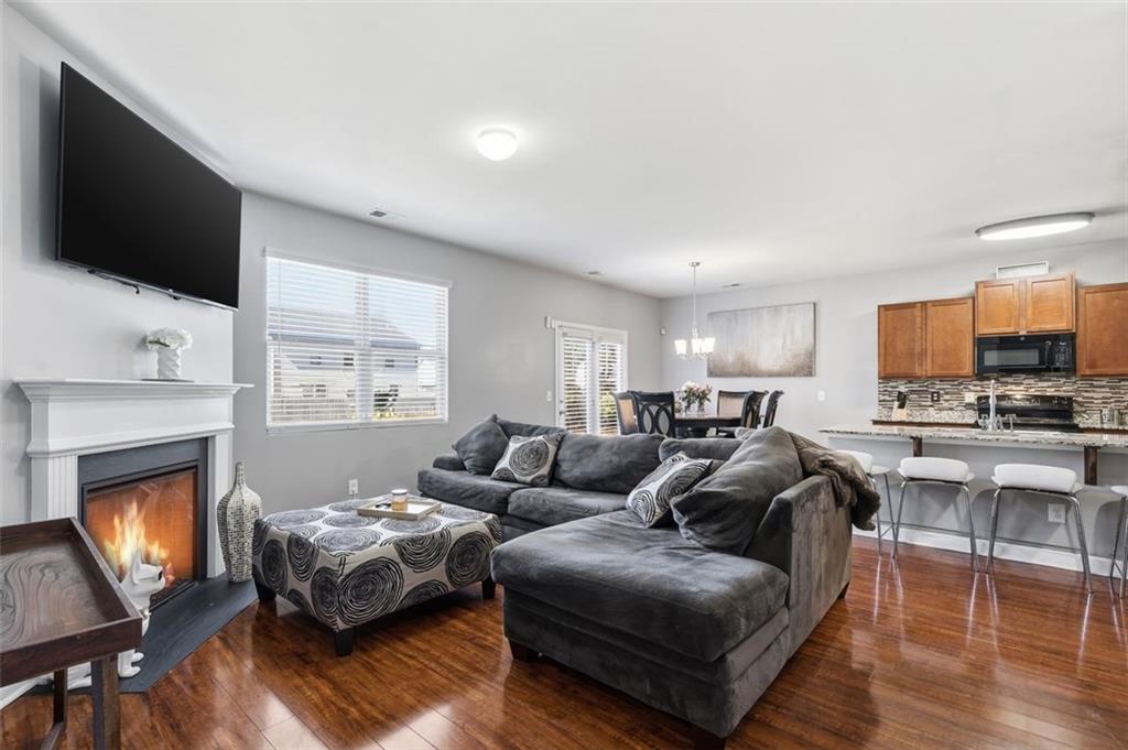 2234 Sawgrass Drive Hampton, GA 30228 - Photo 9 of 28 a living room with furniture a flat screen tv and a fireplace