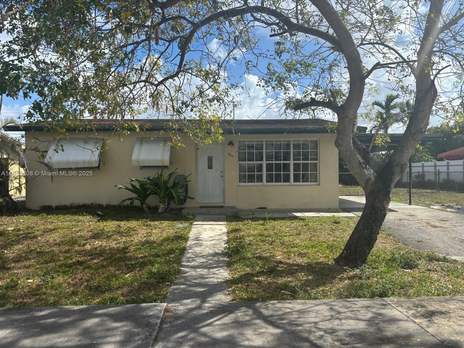 7820 Northwest 175th Street Hialeah, FL 33015 - Photo 1 of 1 a front view of a house with garden
