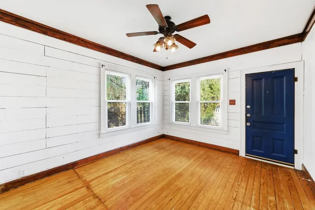 a view of a livingroom with a ceiling fan and window