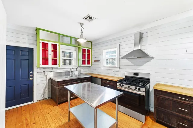 a kitchen with stainless steel appliances granite countertop a stove and a sink