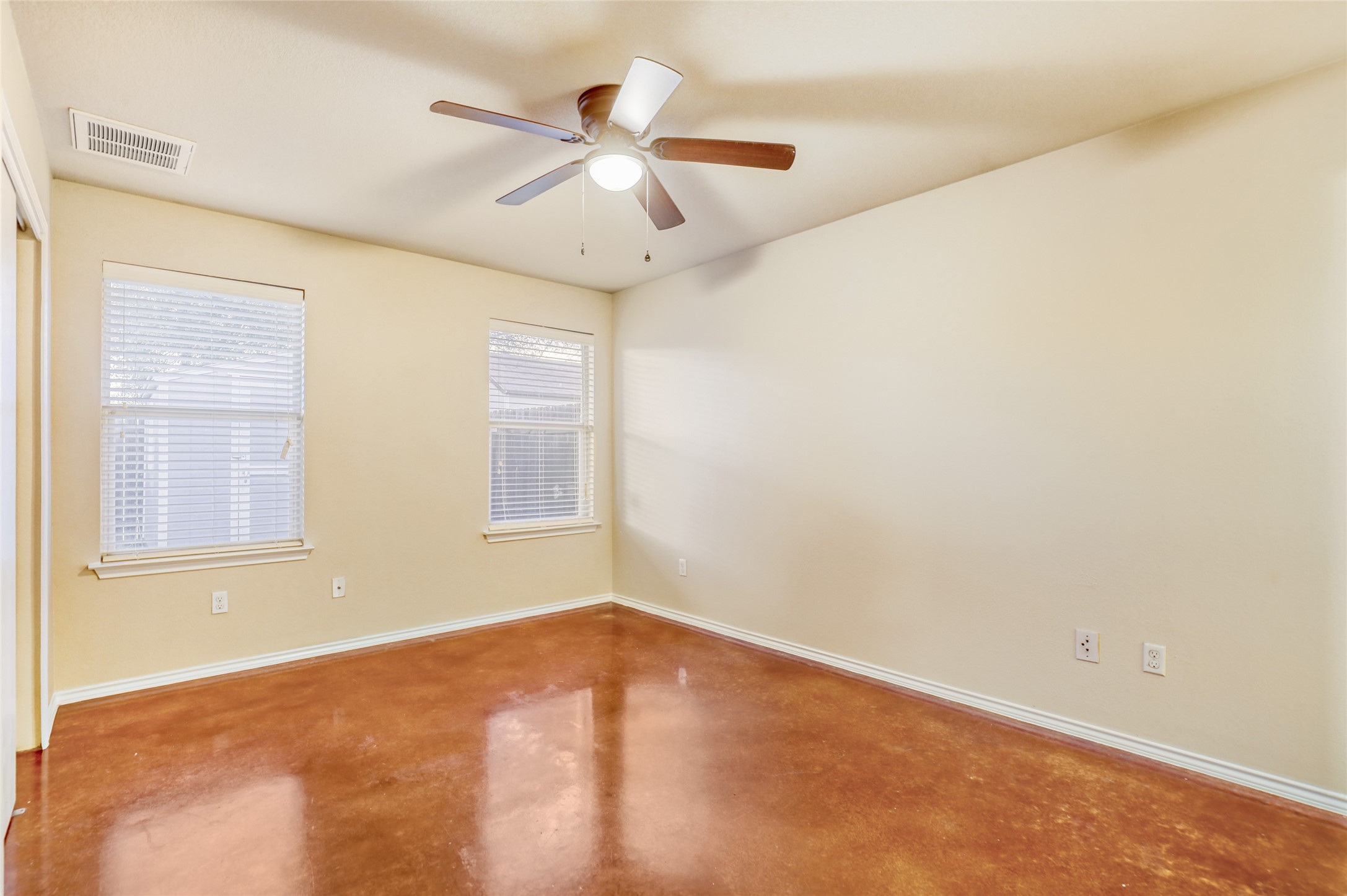 4620 Best Way Austin, TX 78725 - Photo 8 of 11 Unfurnished room featuring finished concrete flooring and ceiling fan
