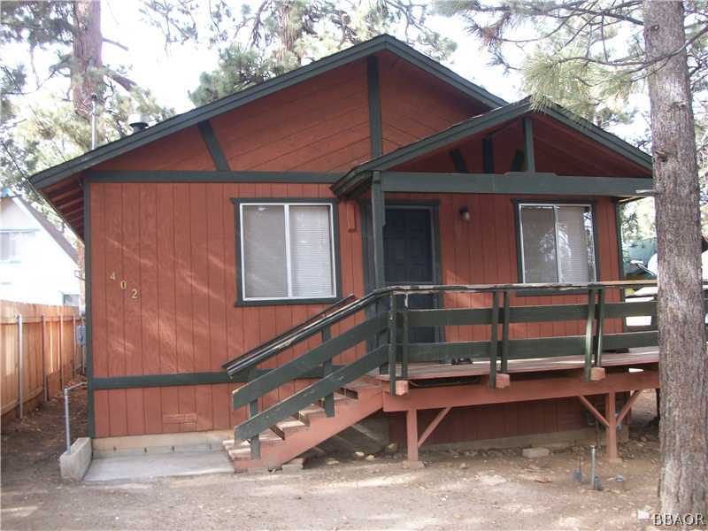 402 Riverside Sugarloaf, CA 92386 - Photo 1 of 18 a front view of a house with a garage