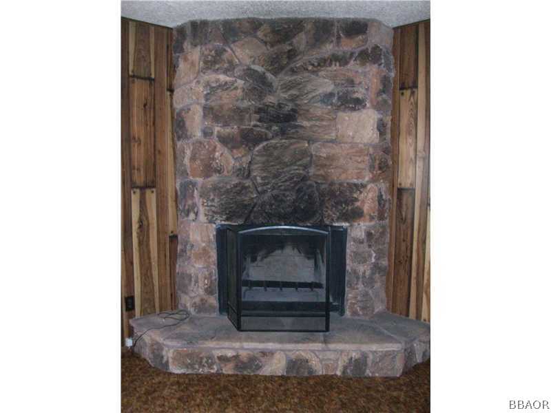 402 Riverside Sugarloaf, CA 92386 - Photo 5 of 18 a stone house with fireplace in it