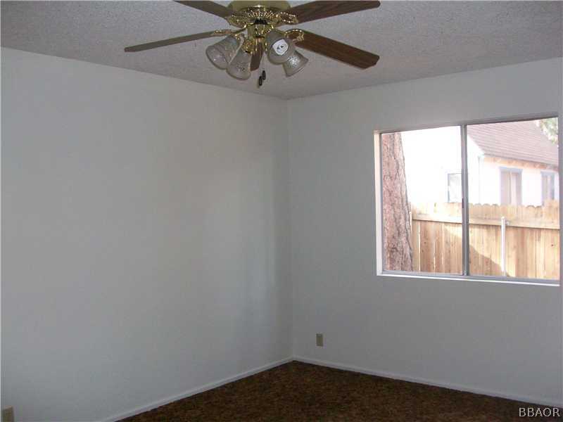 402 Riverside Sugarloaf, CA 92386 - Photo 9 of 18 a view of an empty room with a window