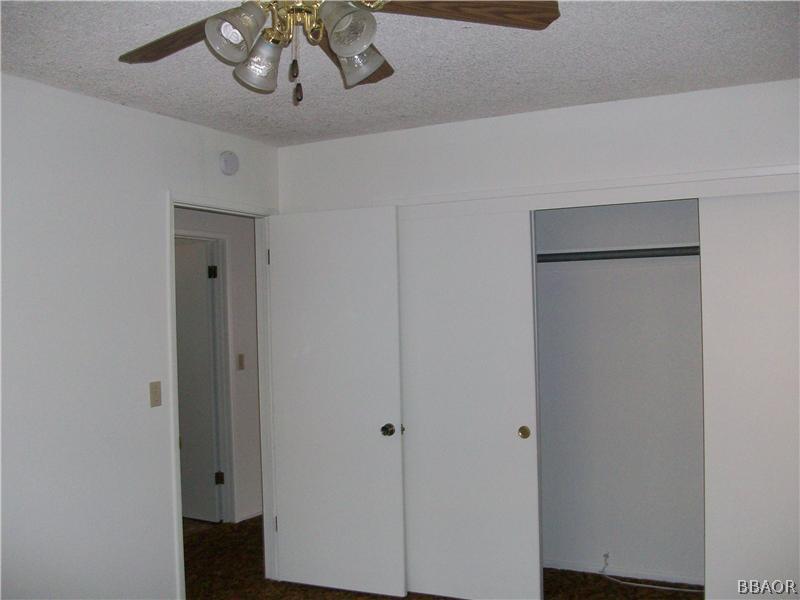 402 Riverside Sugarloaf, CA 92386 - Photo 10 of 18 a view of a hallway with wooden floor