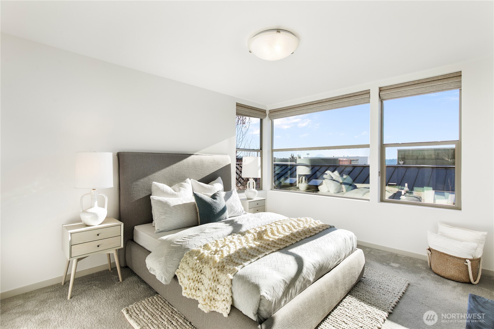 6729 14th Avenue Northwest, Unit B Seattle, WA 98117 - Photo 12 of 36 a bedroom with a bed and a large window